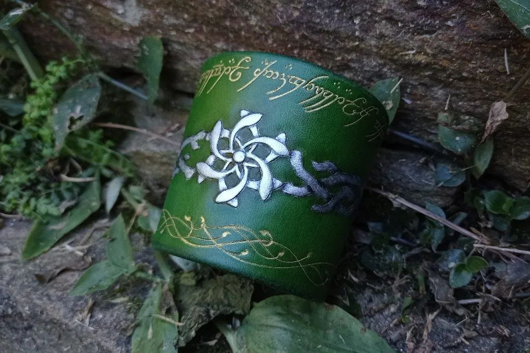 Partially front of the cuff, still over stone, but this time with the fastener attached and the shape closed