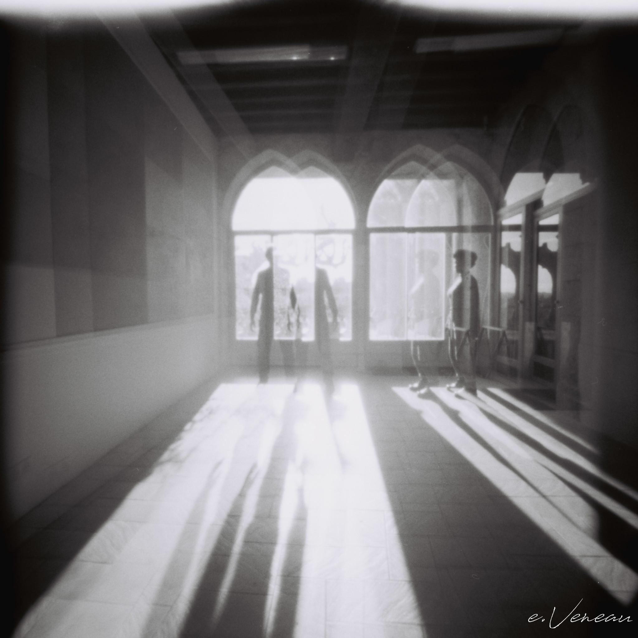 Two silhouettes, one full face and one in profile, against the light, with a shift due to a partial double exposure.