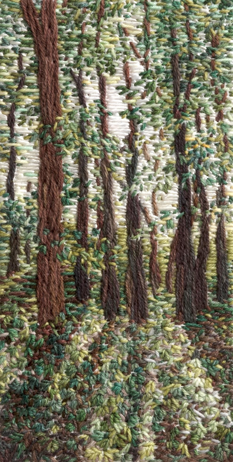 Stitched artwork depicting beech trees in summer. Light shines from behind casting shadows onto the undergrowth
