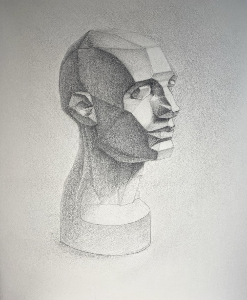 Graphite on Canson drawing paper. 
Drawing of an Asaro head at 3/4 angle with lighting coming from the right. Emphasis is on the face, which is darker than the bottom of the statue (ends at the base of the neck). No background except for light atmospheric shading.