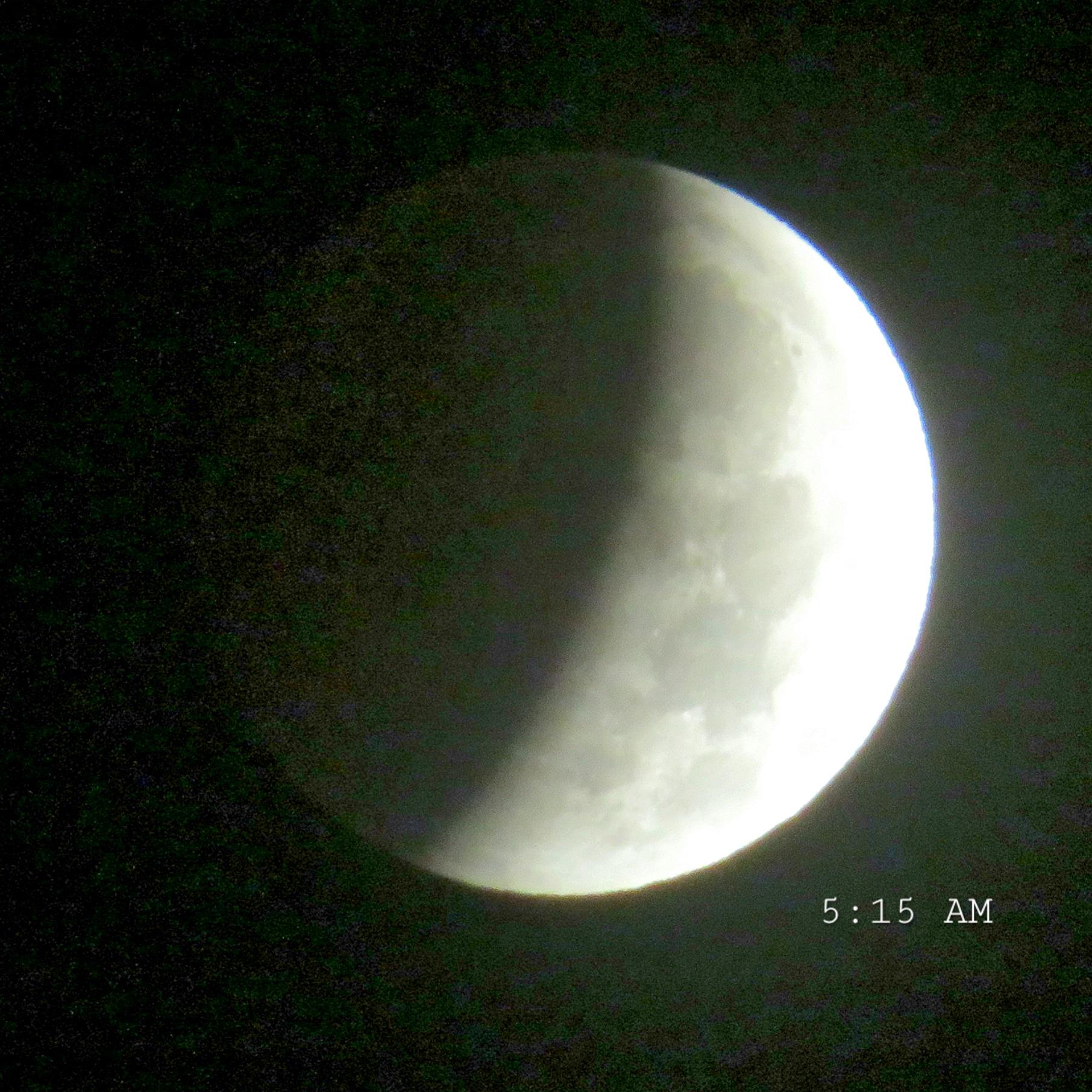 At 5 :15 AM the partial lunar eclipse covering approximately half of the moon.