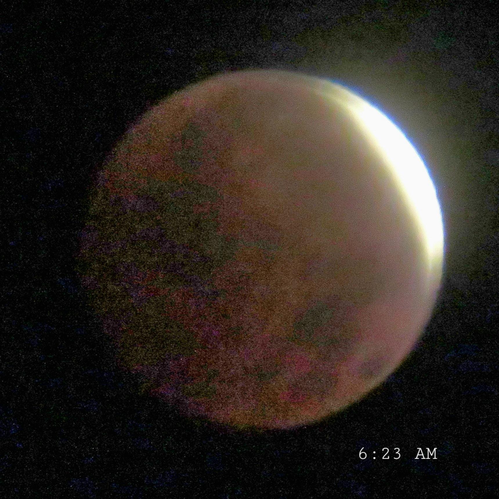 At 6:23 AM the moon was almost obscured by the eclipse and took on a reddish hue.